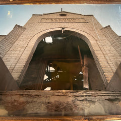 Architectural structure with a clock tower on a reflective surface