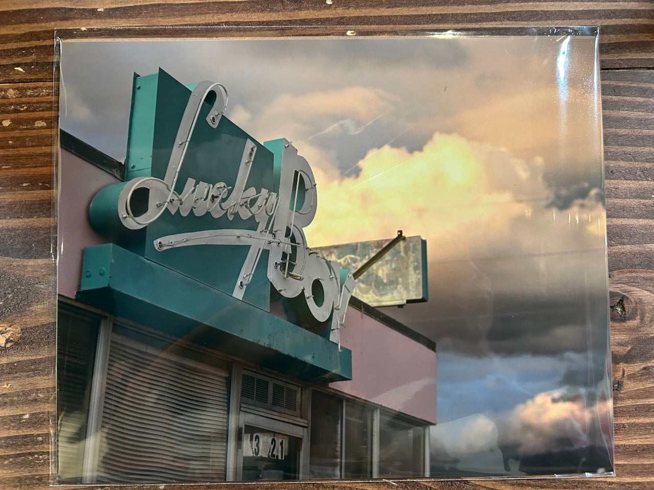 Vintage-style photo of a building with a sign reading 'Lucky Boy' against a cloudy sky.