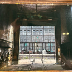 Reflective surface with a distorted view of Albuquerque Rail yard.
